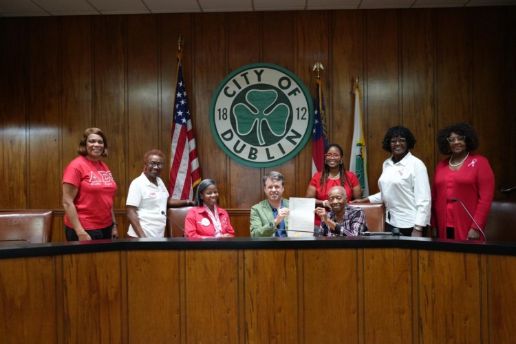 The Sorority smiling with the Mayor.