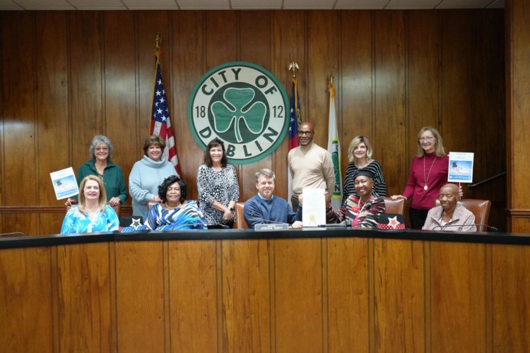 Group of Retired Educators smiling with the Mayor.